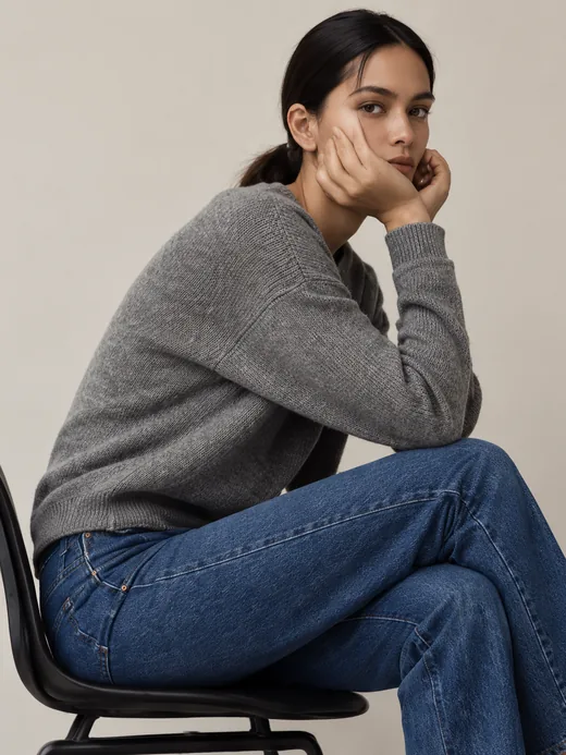 A grey cashmere sweater with straight-leg denim on a model